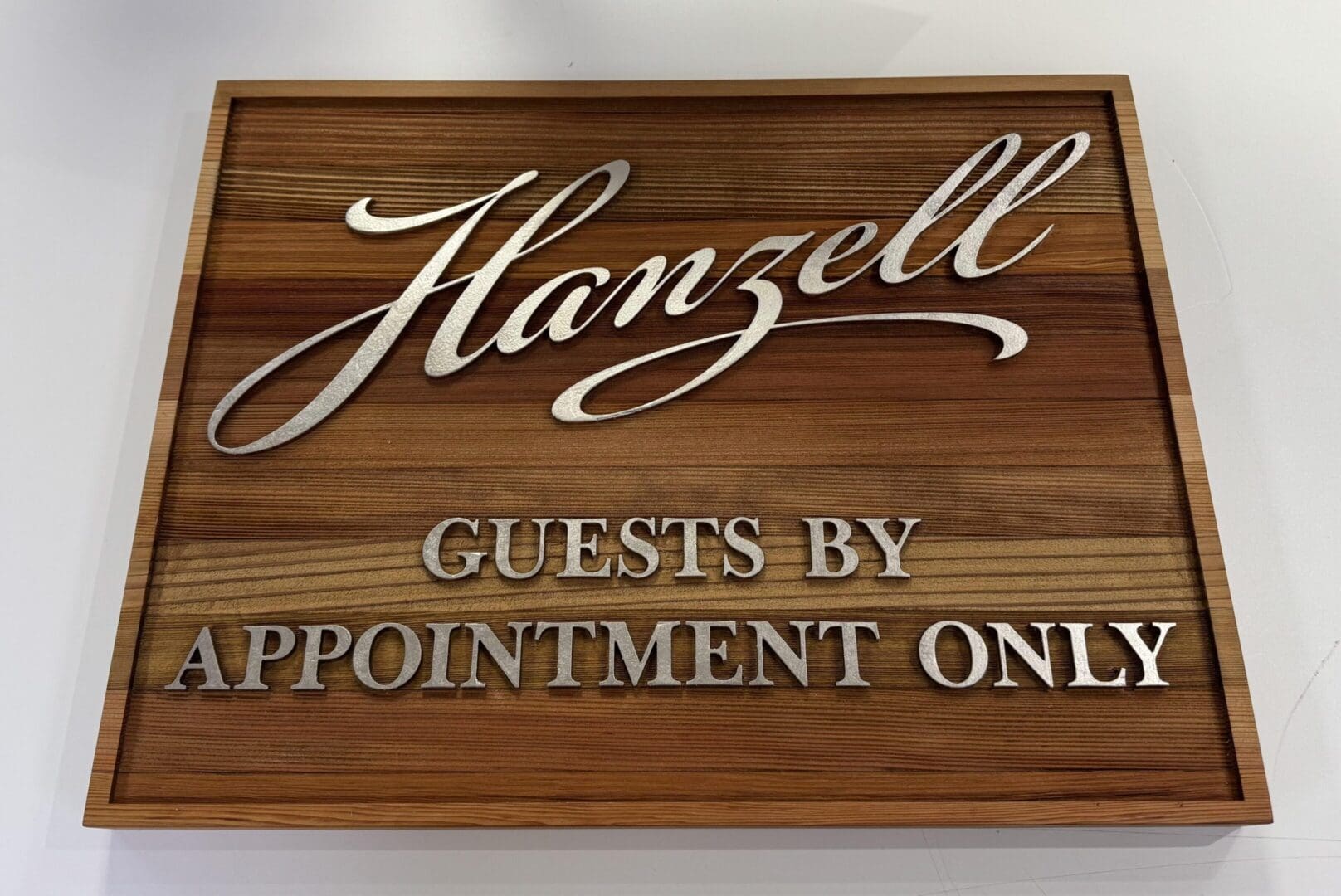 Wooden sign: "Hanzell Guests by Appointment Only.