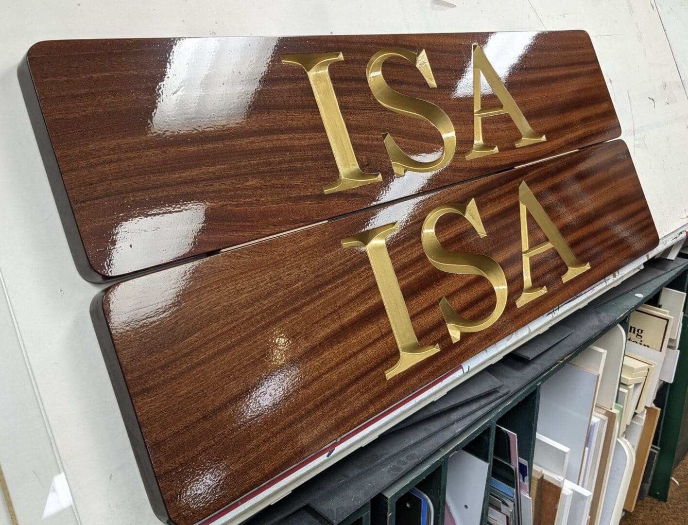 Wooden signs with gold "ISA" letters.