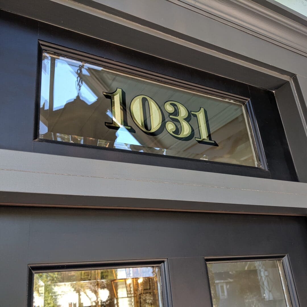House number 1031 on glass panel.
